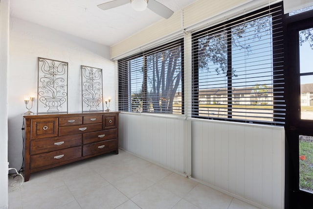 interior space with multiple windows and ceiling fan