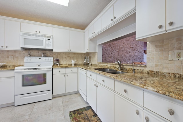 kitchen featuring a textured ceiling, white cabinetry, sink, and white appliances