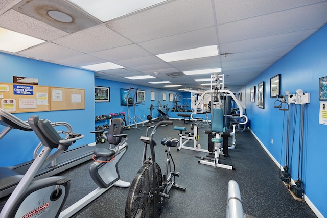 workout area featuring a paneled ceiling