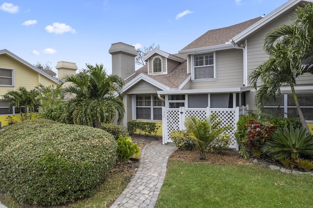 view of front of home with a sunroom