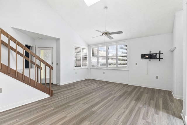 unfurnished living room featuring hardwood / wood-style flooring, ceiling fan, and high vaulted ceiling