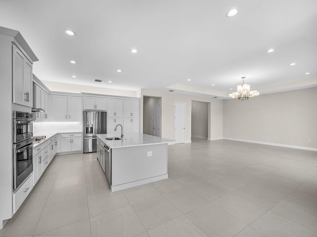 11282 SW Sea Cove Ln, Port Saint Lucie, FL 34987 - kitchen featuring appliances with stainless steel finishes, a sink, a chandelier, light countertops, and open floor plan