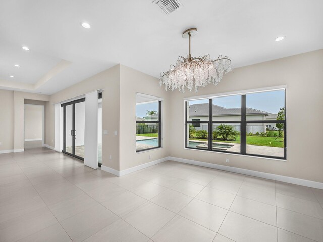 11282 SW Sea Cove Ln, Port Saint Lucie, FL 34987 - spare room featuring french doors, a chandelier, recessed lighting, baseboards, and light tile patterned floors