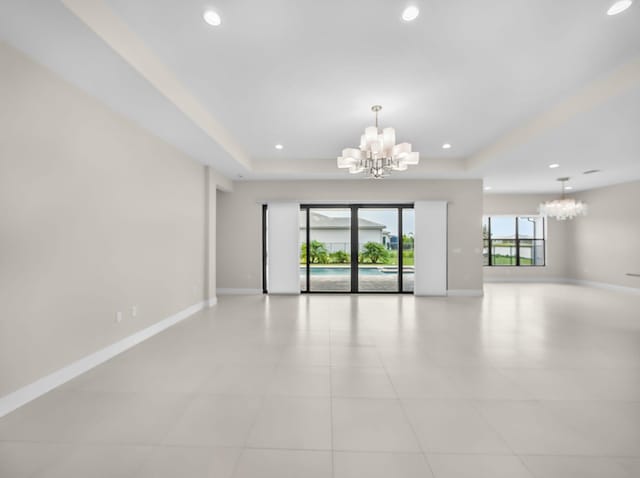11282 SW Sea Cove Ln, Port Saint Lucie, FL 34987 - empty room with a chandelier, a raised ceiling, baseboards, and recessed lighting