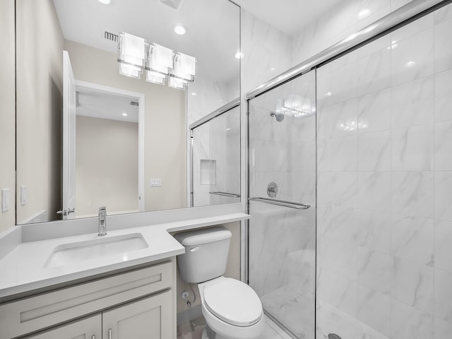 11282 SW Sea Cove Ln, Port Saint Lucie, FL 34987 - bathroom with a shower stall, toilet, vanity, and recessed lighting