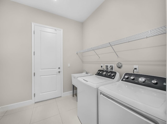 11282 SW Sea Cove Ln, Port Saint Lucie, FL 34987 - laundry area with washer and clothes dryer, baseboards, and light tile patterned floors