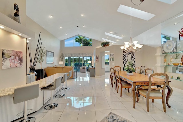 dining space with an inviting chandelier, light tile patterned floors, high vaulted ceiling, and a skylight