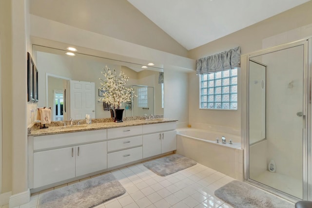 bathroom featuring tile patterned flooring, vanity, vaulted ceiling, and independent shower and bath