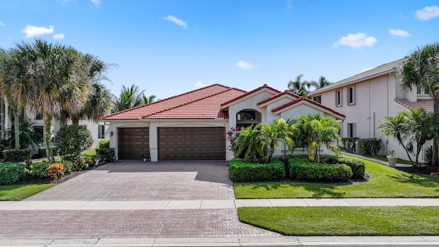 mediterranean / spanish-style house with a front yard and a garage