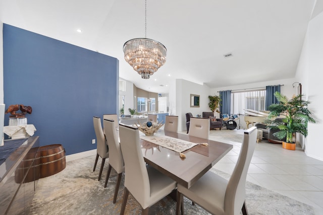 tiled dining room with vaulted ceiling and a notable chandelier