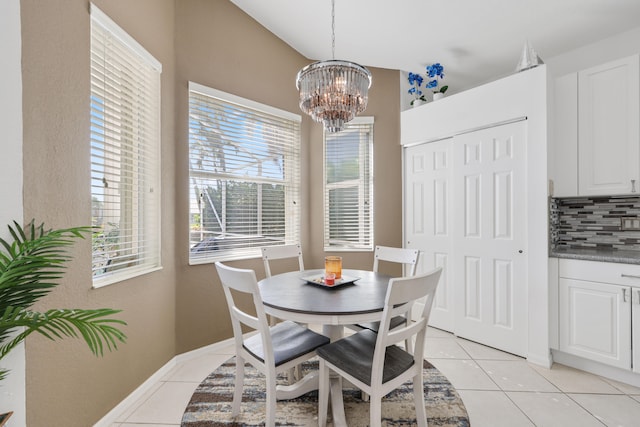 tiled dining area featuring a notable chandelier