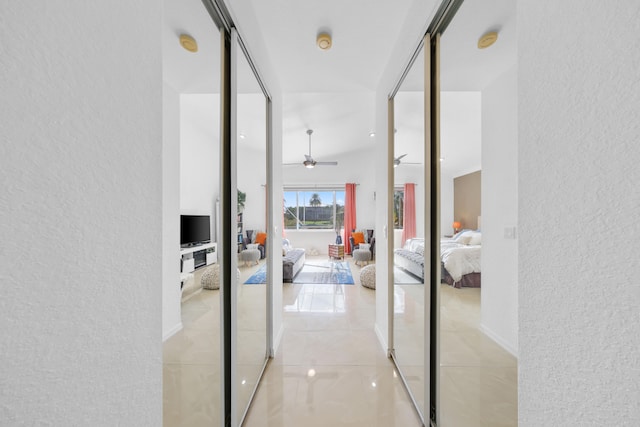 hall featuring light tile patterned floors