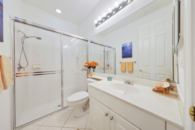 bathroom featuring vanity, toilet, walk in shower, and tile patterned floors