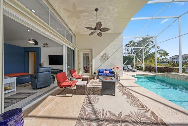 view of patio / terrace with ceiling fan, glass enclosure, and a fire pit