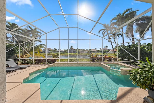 view of pool with glass enclosure, an in ground hot tub, a water view, and a patio