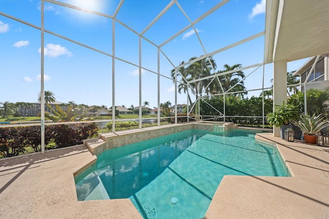 view of swimming pool featuring a patio and a lanai