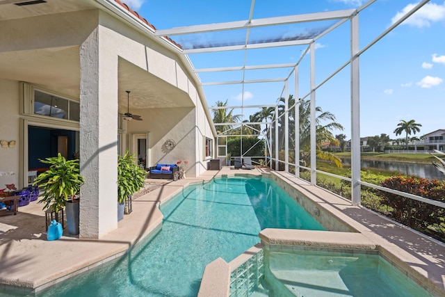 view of swimming pool featuring a patio area, an in ground hot tub, a lanai, and a water view