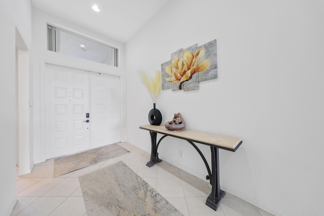 entrance foyer featuring a high ceiling and light tile patterned floors