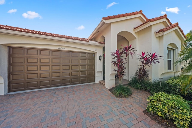 mediterranean / spanish house with a garage