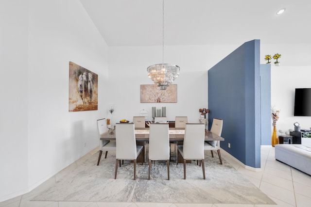 dining room with an inviting chandelier, vaulted ceiling, and light tile patterned floors