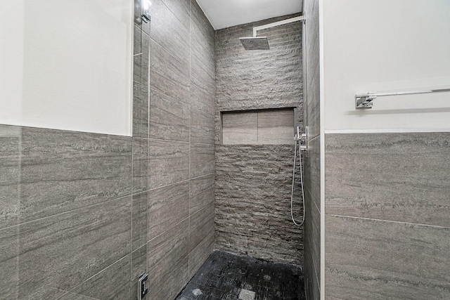 bathroom featuring tile walls and tiled shower