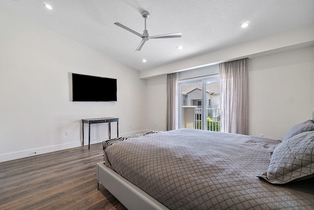 bedroom featuring a textured ceiling, dark hardwood / wood-style flooring, vaulted ceiling, and ceiling fan