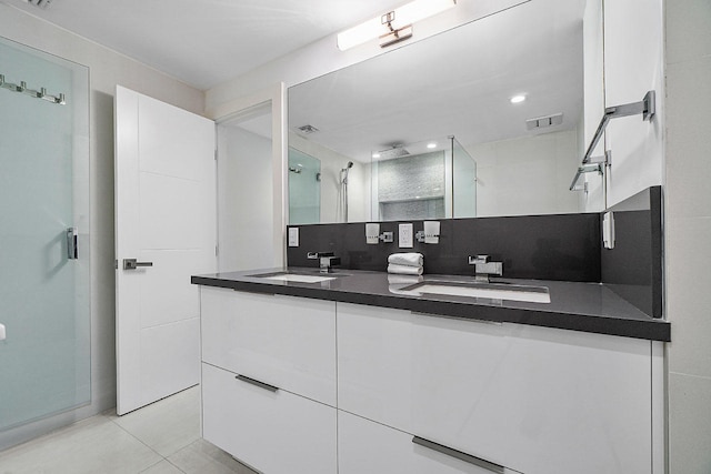 bathroom featuring backsplash, tile patterned floors, vanity, and walk in shower