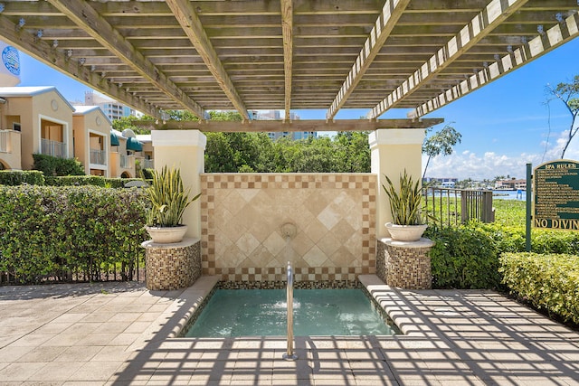 view of patio / terrace featuring an in ground hot tub and a pergola