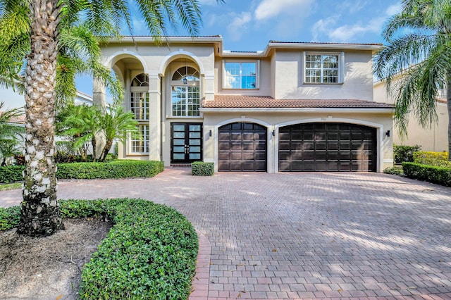 mediterranean / spanish home with a garage