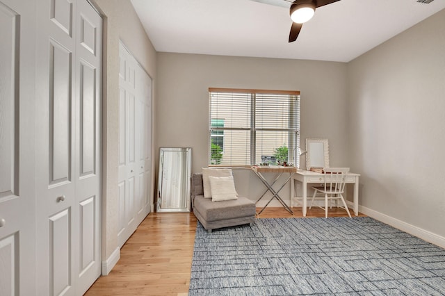 sitting room featuring ceiling fan and light wood-type flooring