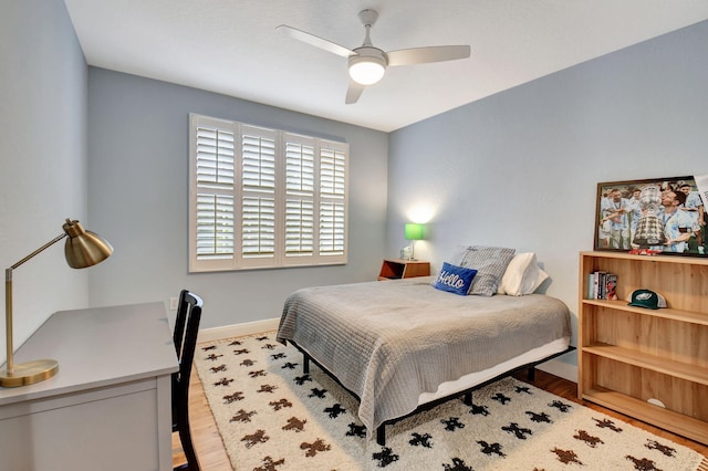 bedroom with ceiling fan and light wood-type flooring