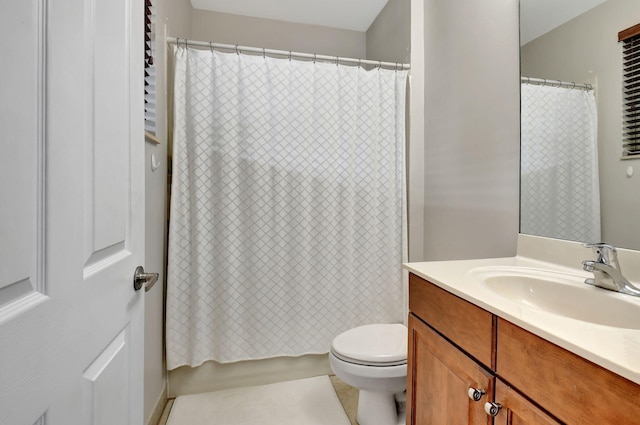 bathroom featuring tile patterned flooring, vanity, and toilet