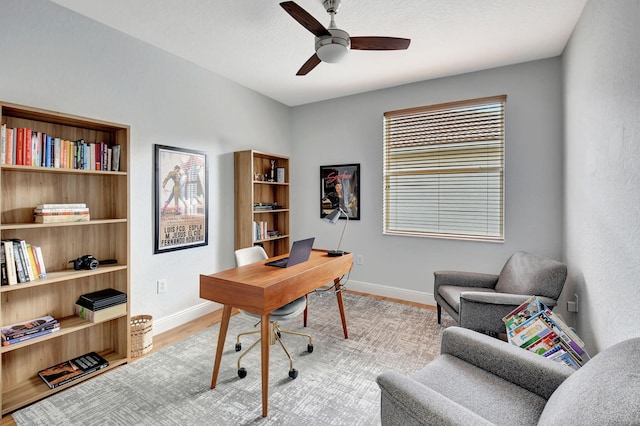 office with ceiling fan and light hardwood / wood-style flooring