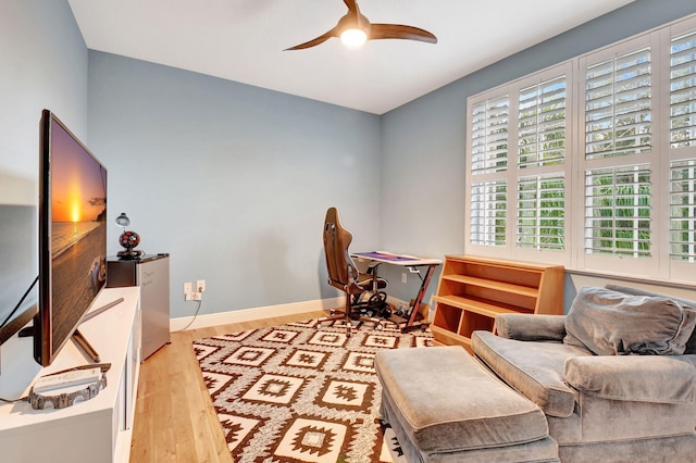 office space featuring ceiling fan and light hardwood / wood-style floors