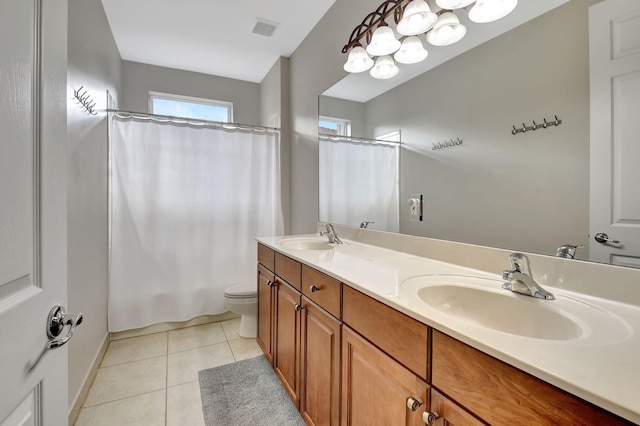 bathroom featuring toilet, vanity, and tile patterned floors