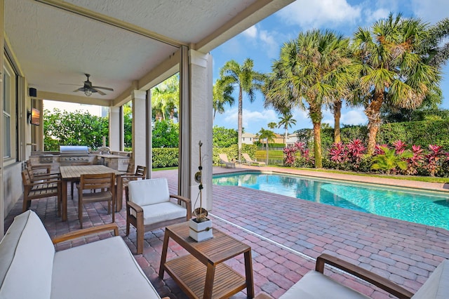 view of pool featuring area for grilling, ceiling fan, and a patio