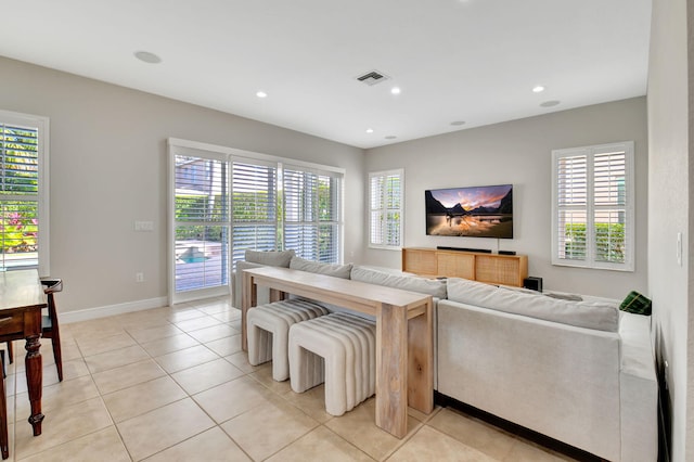 living room with light tile patterned floors and a healthy amount of sunlight