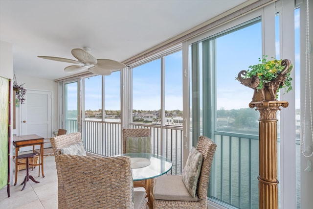 sunroom / solarium with a water view, a wealth of natural light, and ceiling fan