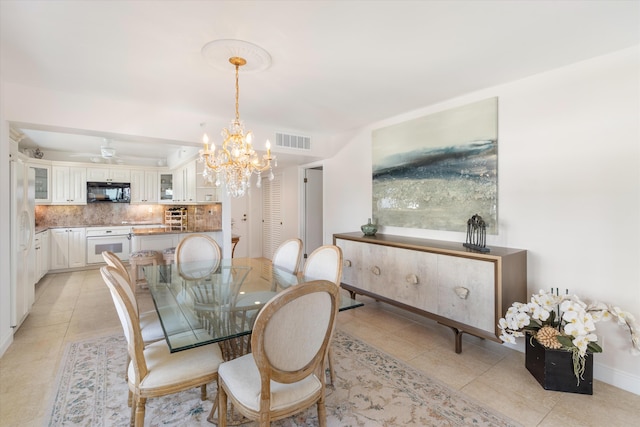 dining room featuring visible vents, baseboards, ceiling fan with notable chandelier, and light tile patterned floors