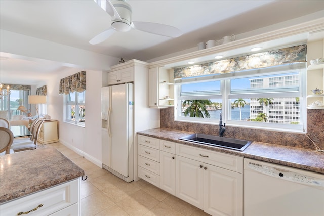kitchen featuring open shelves, a ceiling fan, white appliances, a sink, and backsplash