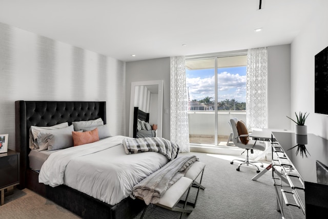 carpeted bedroom featuring floor to ceiling windows