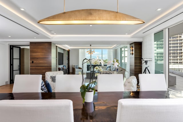 dining space featuring floor to ceiling windows and a notable chandelier