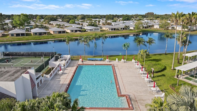 view of swimming pool featuring a water view and a patio area