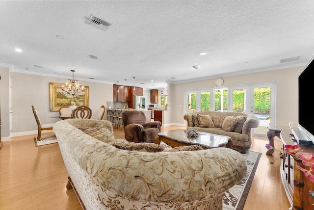 living room with light wood-type flooring and a textured ceiling