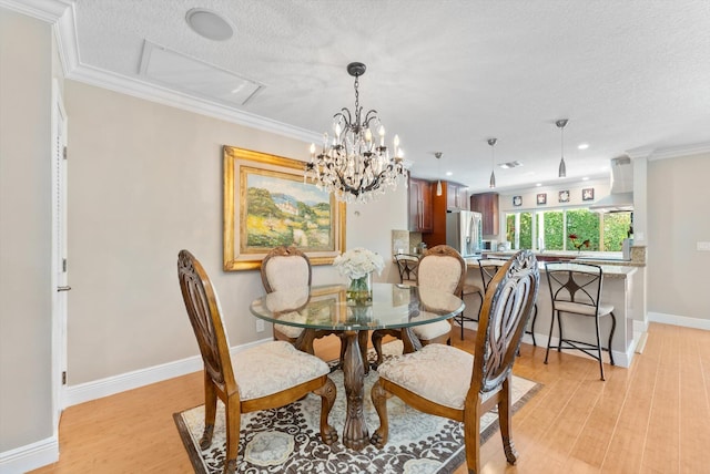 dining area with crown molding, a textured ceiling, and light wood-type flooring