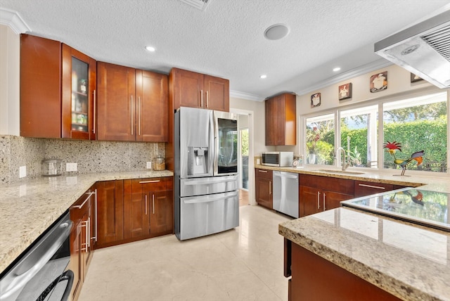 kitchen featuring tasteful backsplash, a textured ceiling, stainless steel appliances, crown molding, and sink