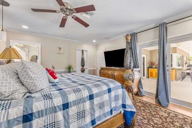 bedroom with ceiling fan, hardwood / wood-style floors, and ornamental molding