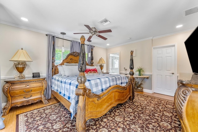 bedroom with hardwood / wood-style flooring, ceiling fan, and crown molding