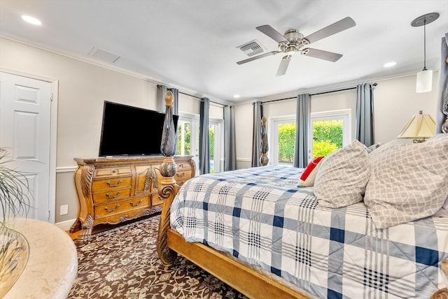 bedroom with ceiling fan and ornamental molding