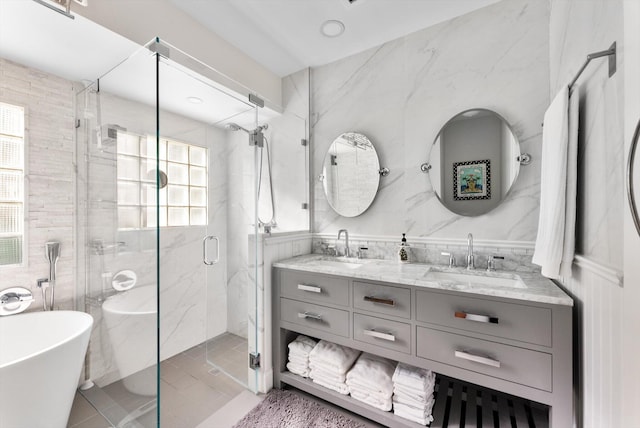 bathroom with separate shower and tub, tile patterned floors, vanity, and tile walls